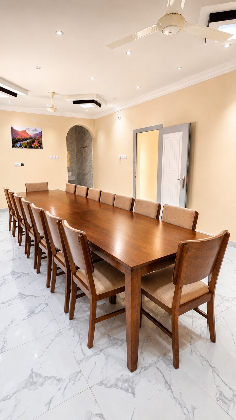 Indoor dining room with a long wooden table and upholstered chairs